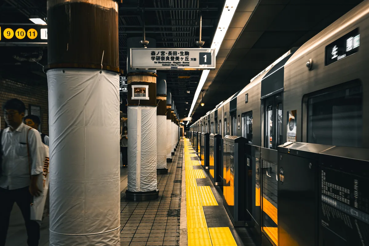 A subway platform and train in Osaka, representative of getting around the city by Osaka Metro